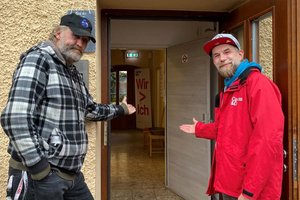 Eggerheim-Besucher Erik und Sozialarbeiter Marin Göhler danken allen Eggerheim-Unterstützer*innen und bitten in die Einrichtung. Foto: Caritas 